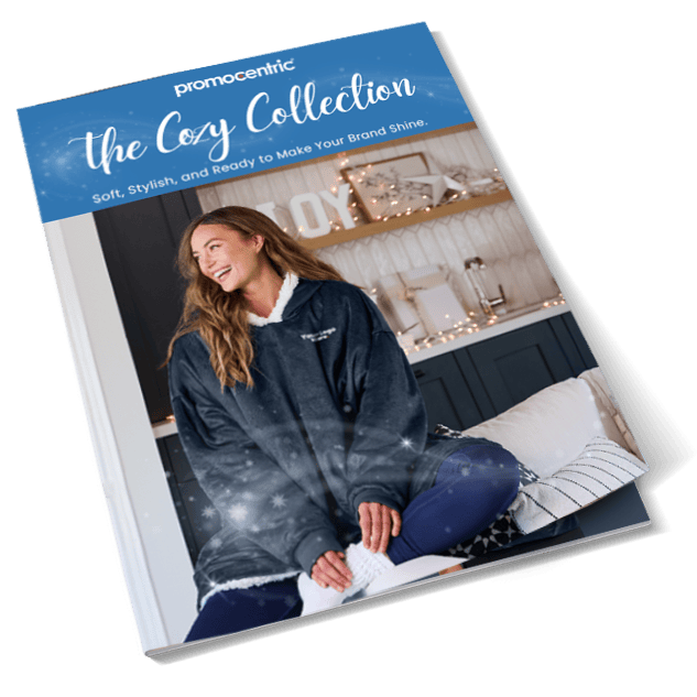 Cozy happy woman wearing branded blanket, holiday gifting