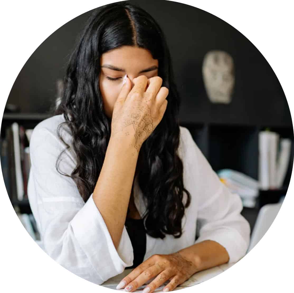 Woman with her face in her hand.